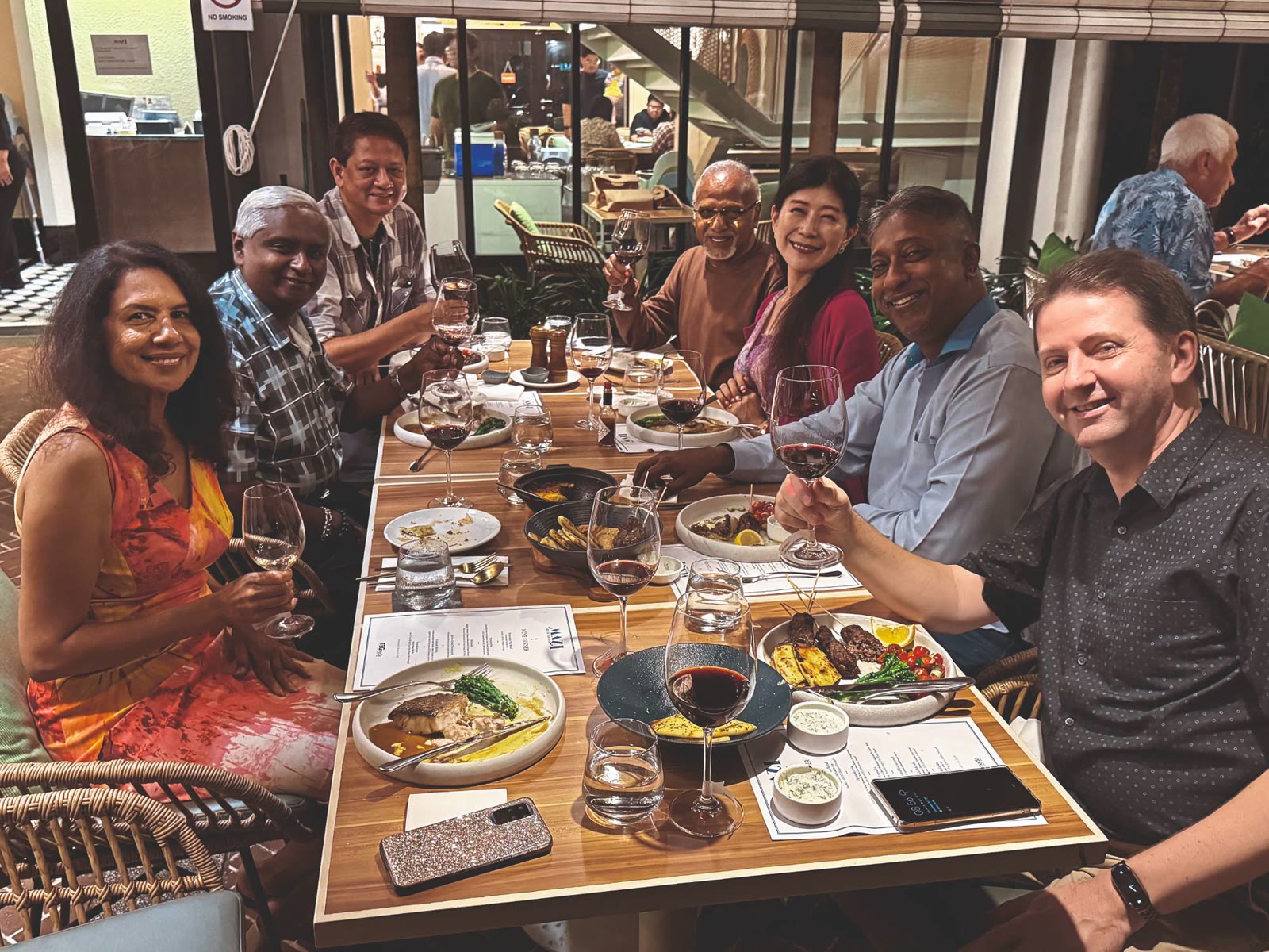 Guests raising a glass at a TEG Wine Dinner